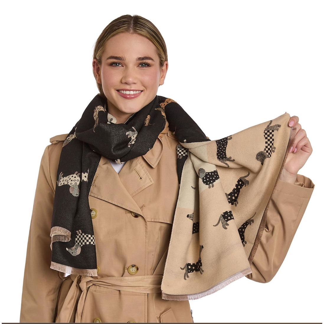 Woman wearing a beige trench coat with a patterned scarf, holding another scarf with animal designs.