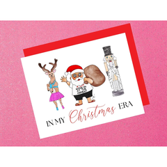 Christmas-themed card with cartoon characters on a pink background