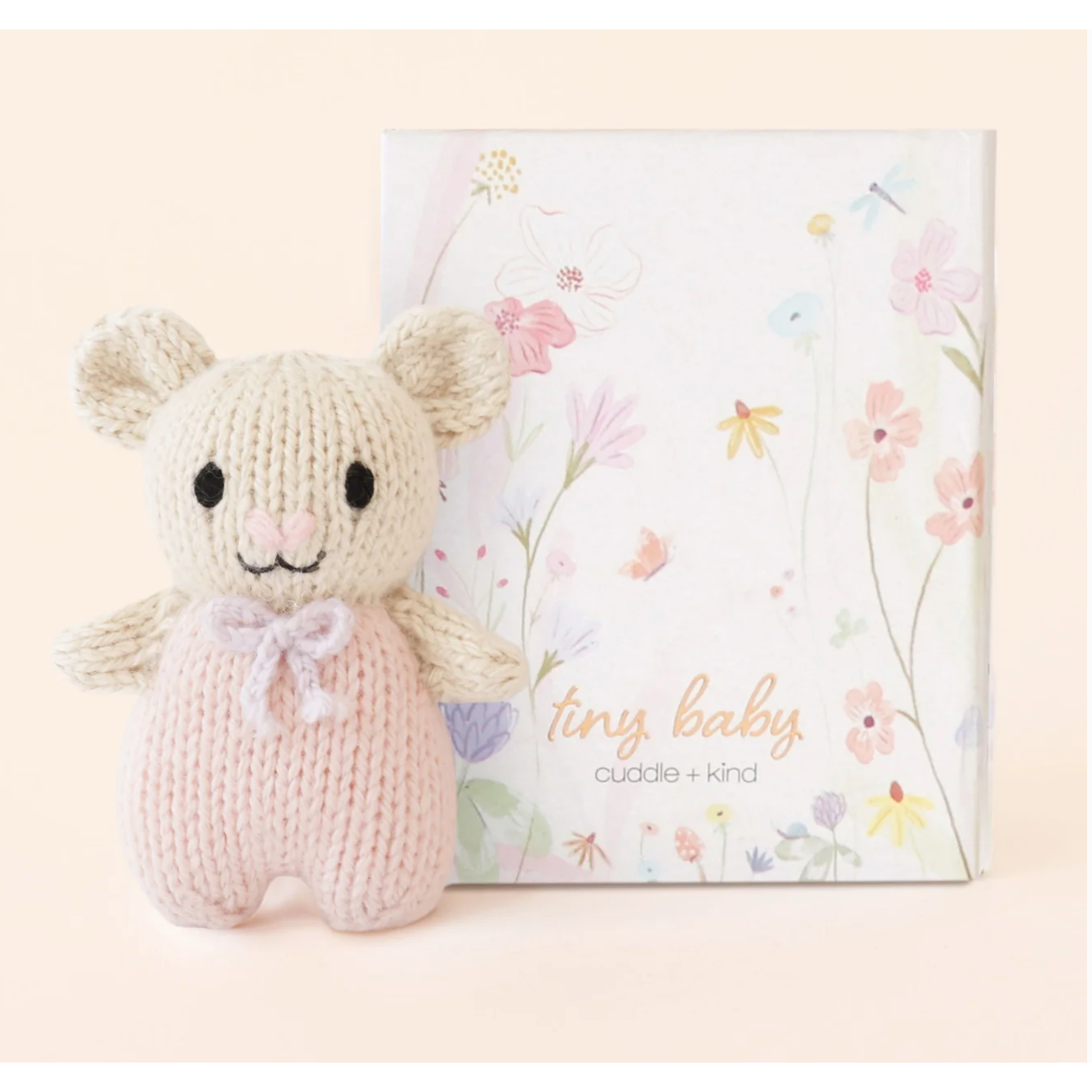 Knitted mouse toy with a floral-themed card on a light pink background