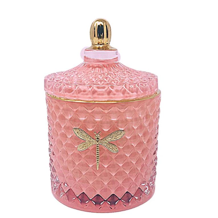 Pink textured jar with gold lid and dragonfly design on a white background