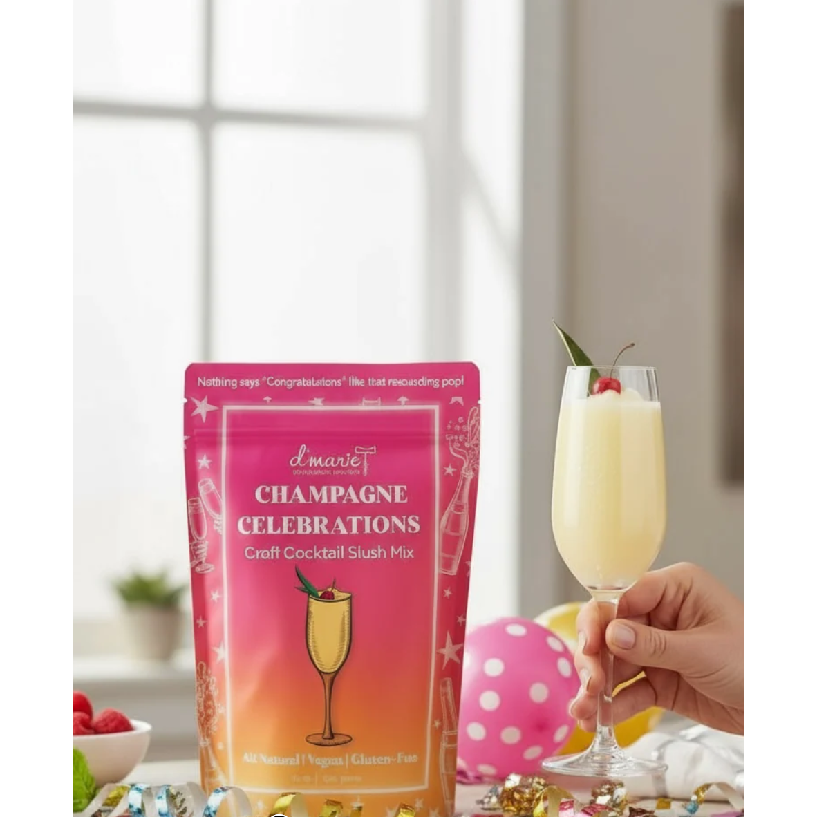 Packaging of d'marie Champagne Celebrations cocktail mix with a glass of champagne cocktail.