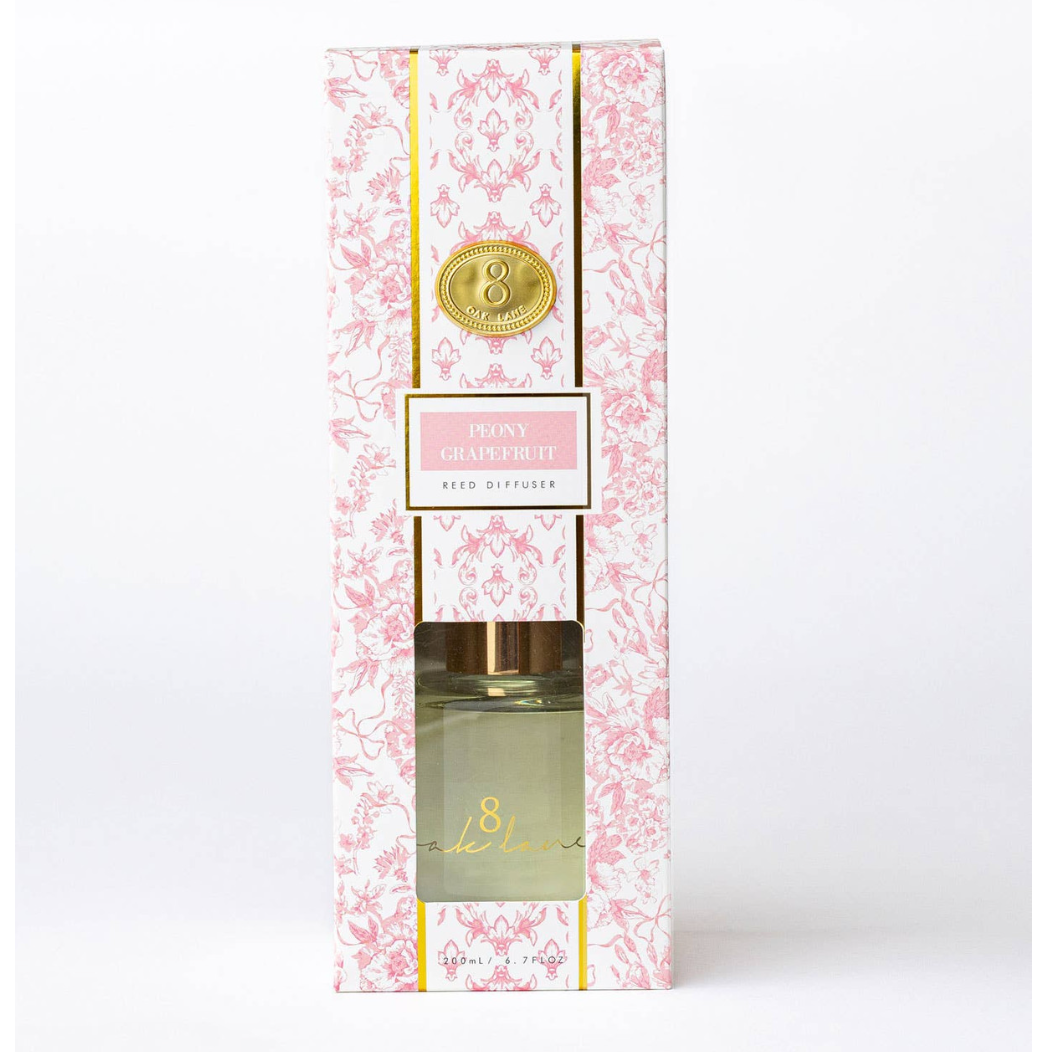 Decorative diffuser packaging with floral design and gold accents on a white background