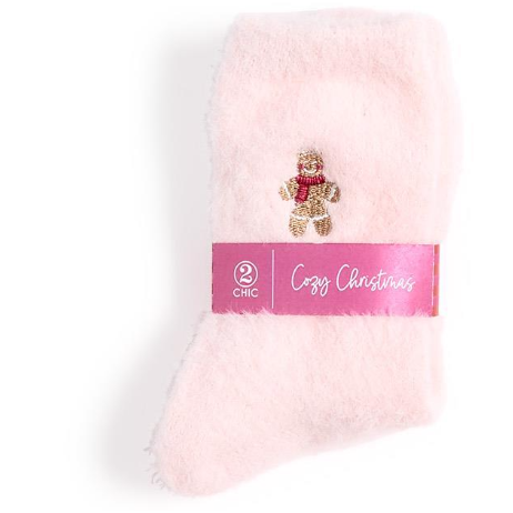 Pink fuzzy blanket with a gingerbread man charm and 'Cozy Christmas' label on a white background