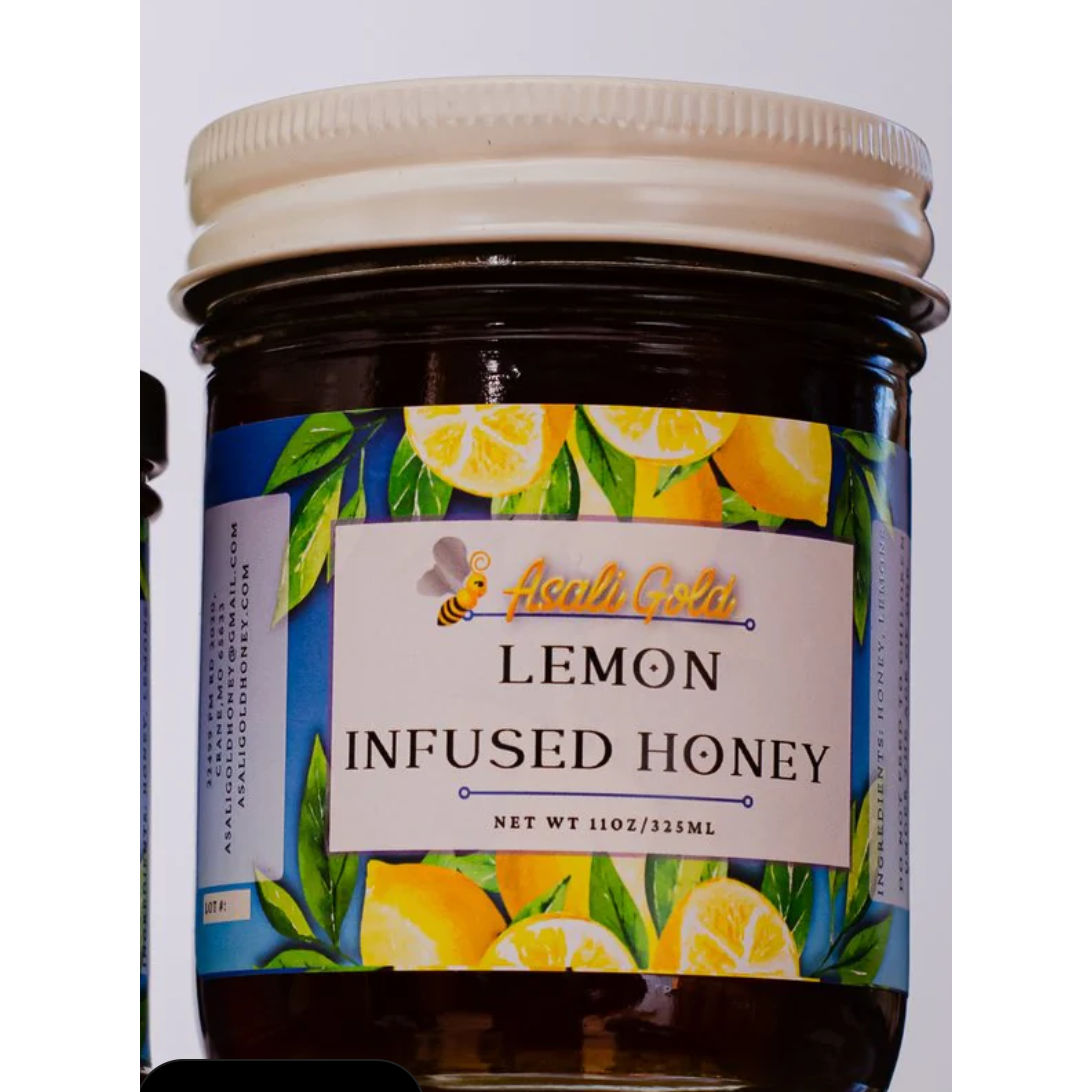 Jar of lemon infused honey with a visible label on a white background