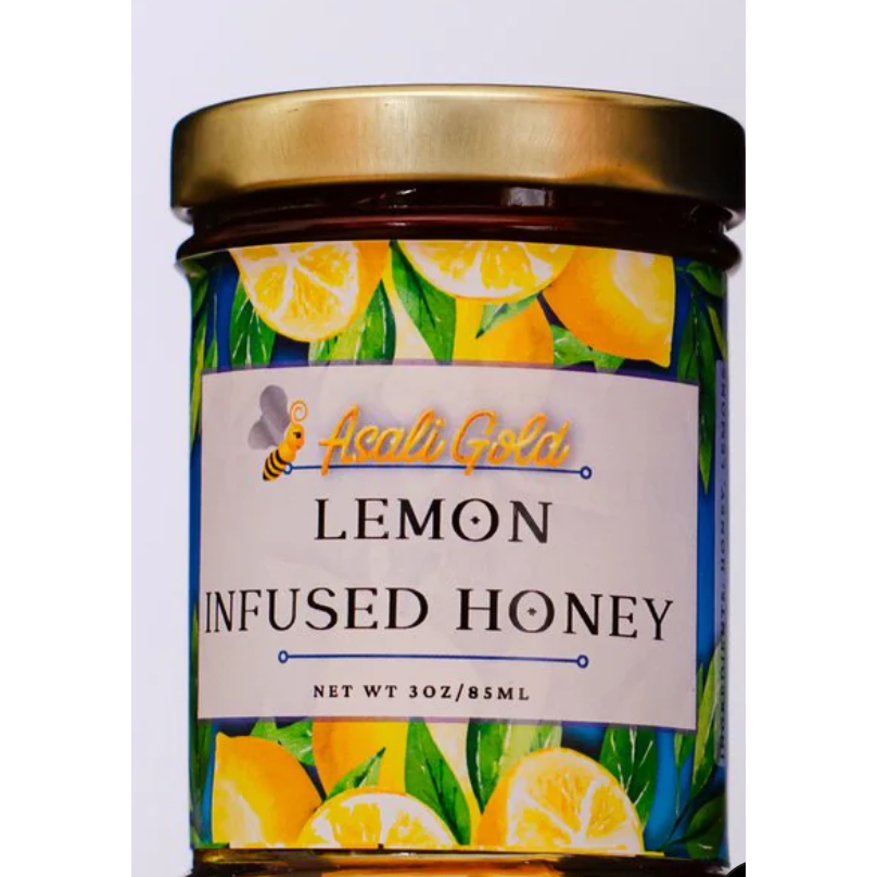 Jar of lemon infused honey with a colorful label featuring lemons and Asali Gold branding.