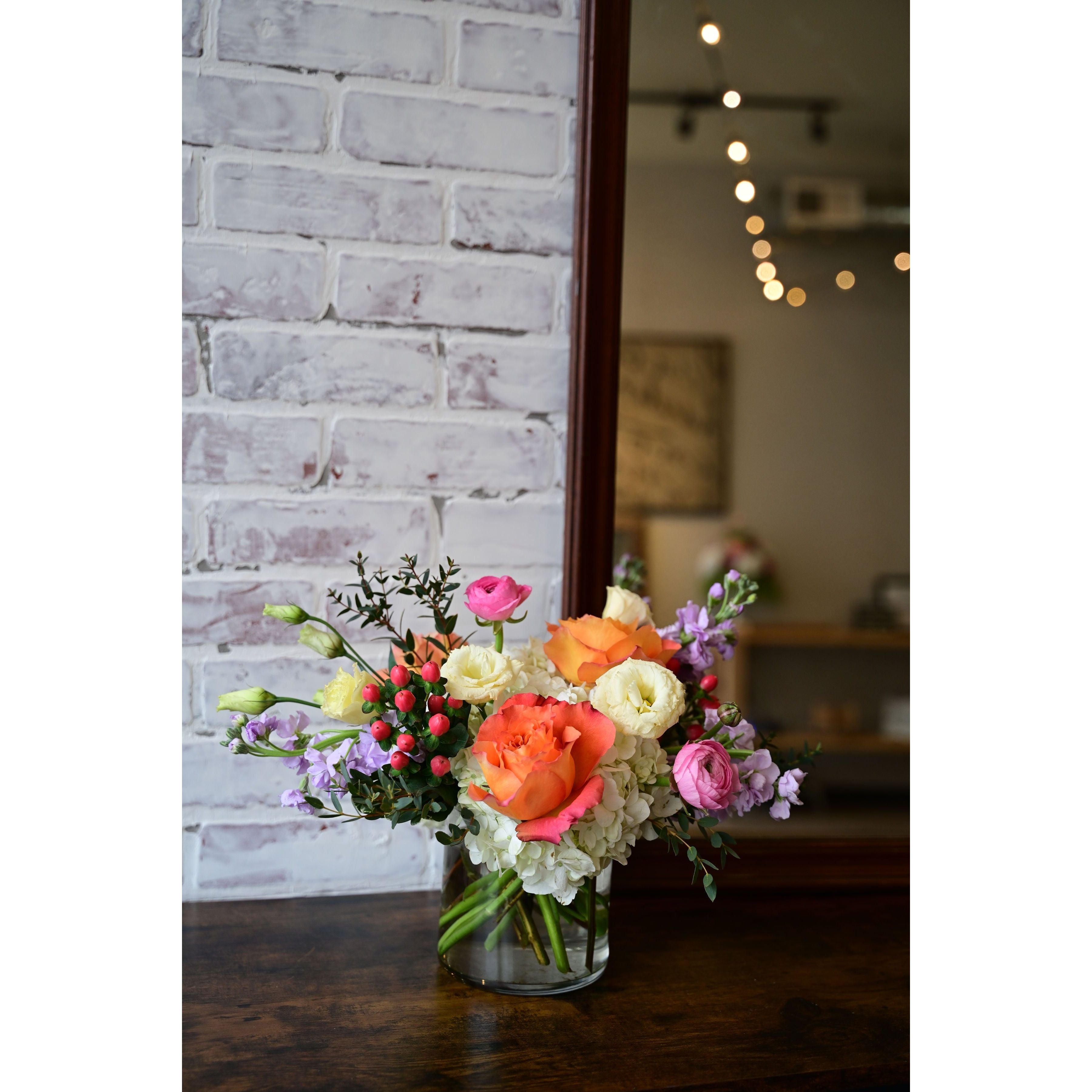 Pastel Perfection floral arrangement with roses, ranunculus, lisianthus, and hydrangeas in a clear vase from White Farmhouse Flowers Parkville MO