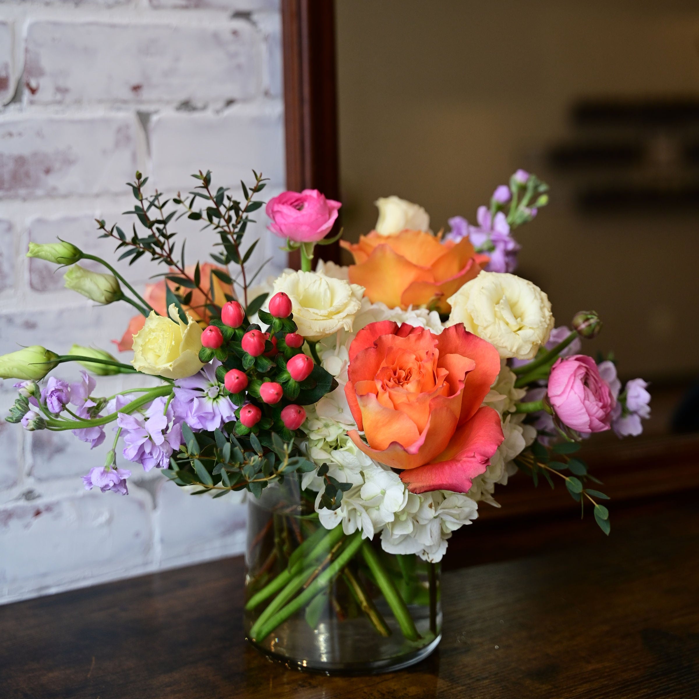 Pastel Perfection floral arrangement with roses, ranunculus, lisianthus, and hydrangeas in a clear vase from White Farmhouse Flowers Parkville MO