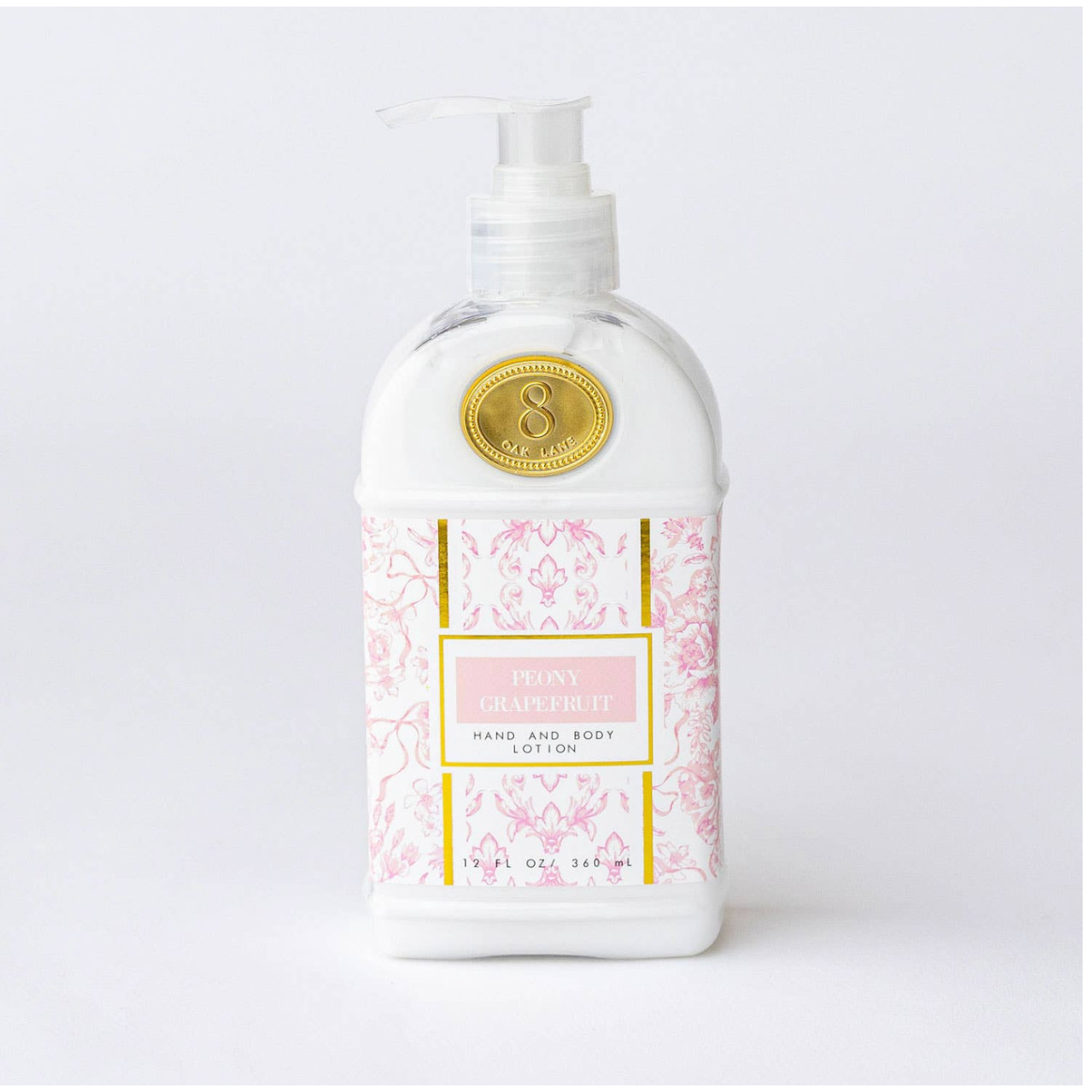 Hand and body lotion bottle with decorative label on a white background