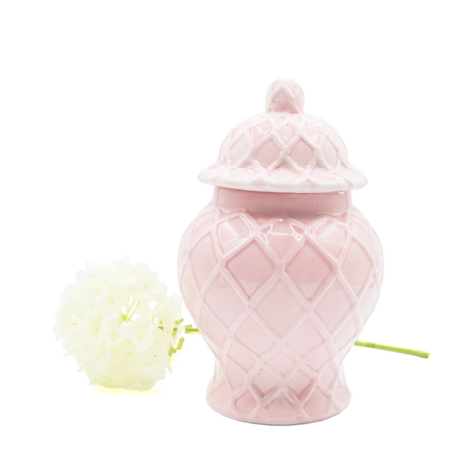 Pink ceramic jar with a geometric pattern on a white background