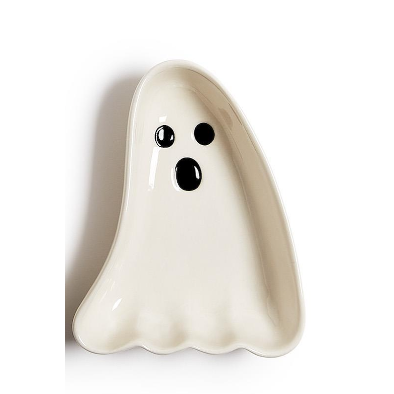 A ghost-shaped ceramic dish in off-white with a black face, photographed on a plain white background.