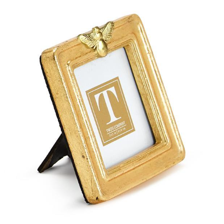 Gold picture frame with a butterfly design on a white background