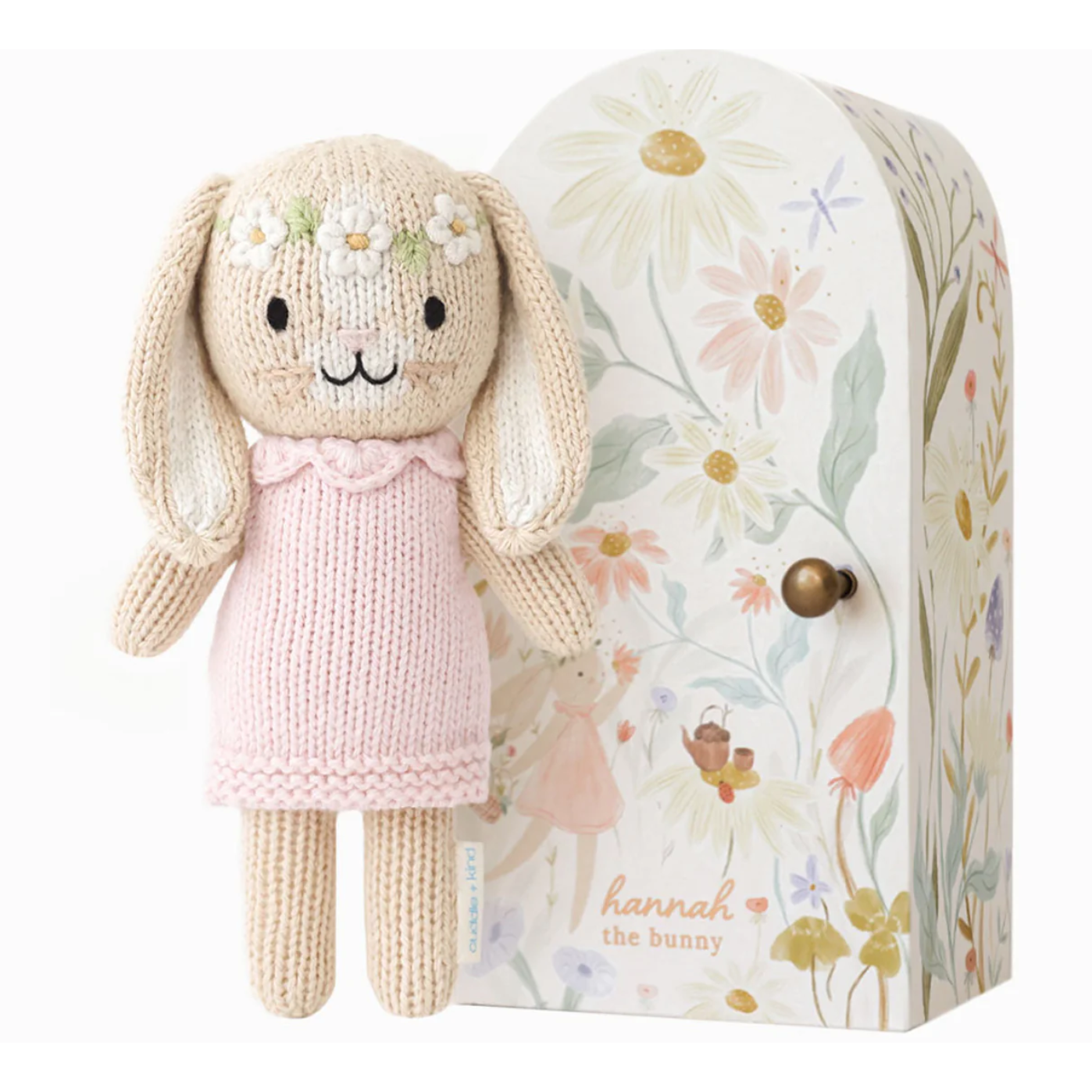 Knitted bunny toy with a floral design on its packaging