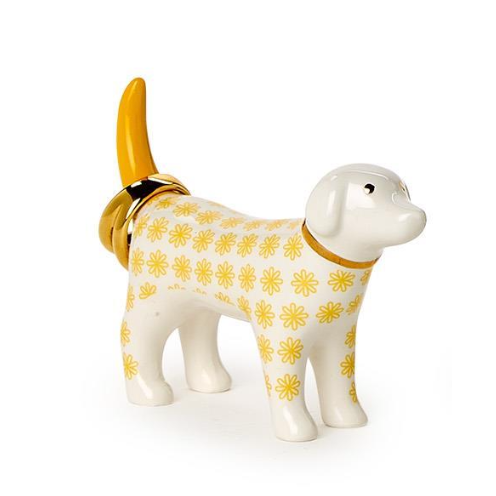 Dog-shaped object with yellow floral pattern and gold accents on a white background