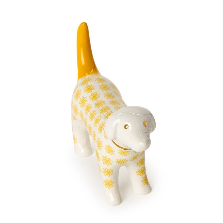 Ceramic dog figurine with yellow floral pattern on a white background