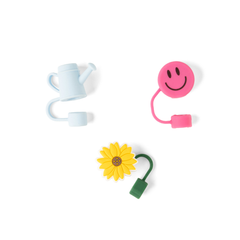 Colorful toy accessories including a watering can, smiley face, and sunflower on a white background
