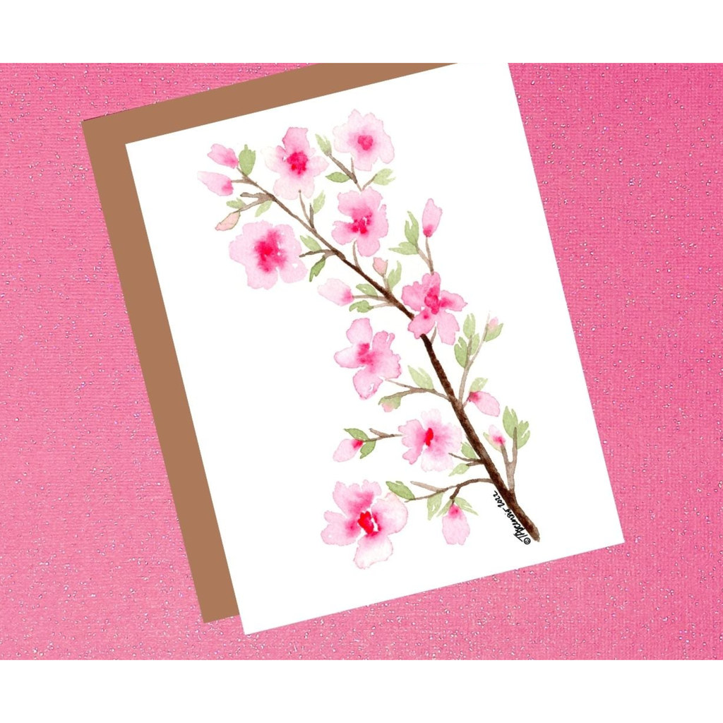 Greeting card with cherry blossom design on a pink background