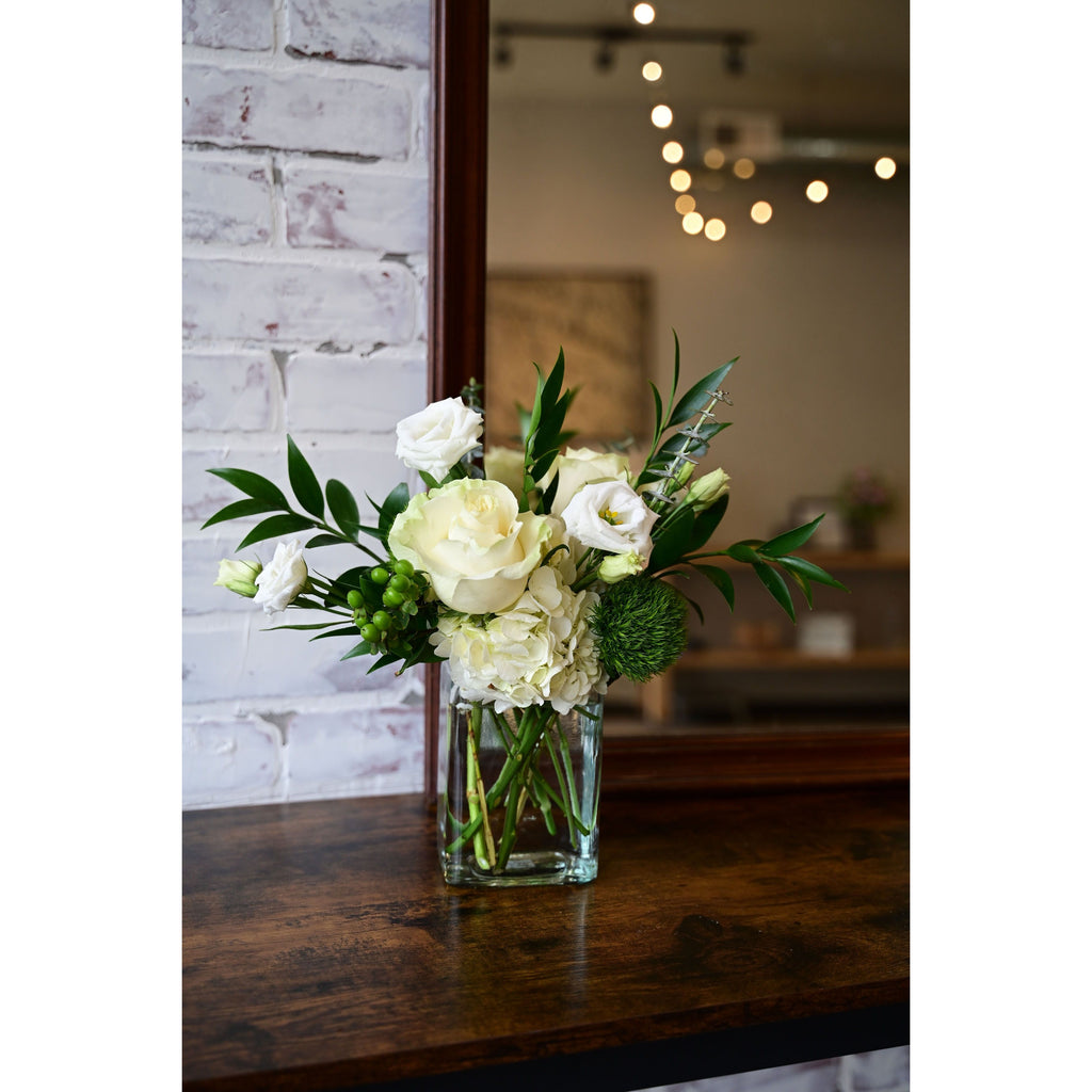Green and White Bouquet with roses, hydrangeas, lisianthus, and greenery in a clear vase from White Farmhouse Flowers Parkville MO