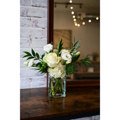 Green and White Bouquet with roses, hydrangeas, lisianthus, and greenery in a clear vase from White Farmhouse Flowers Parkville MO