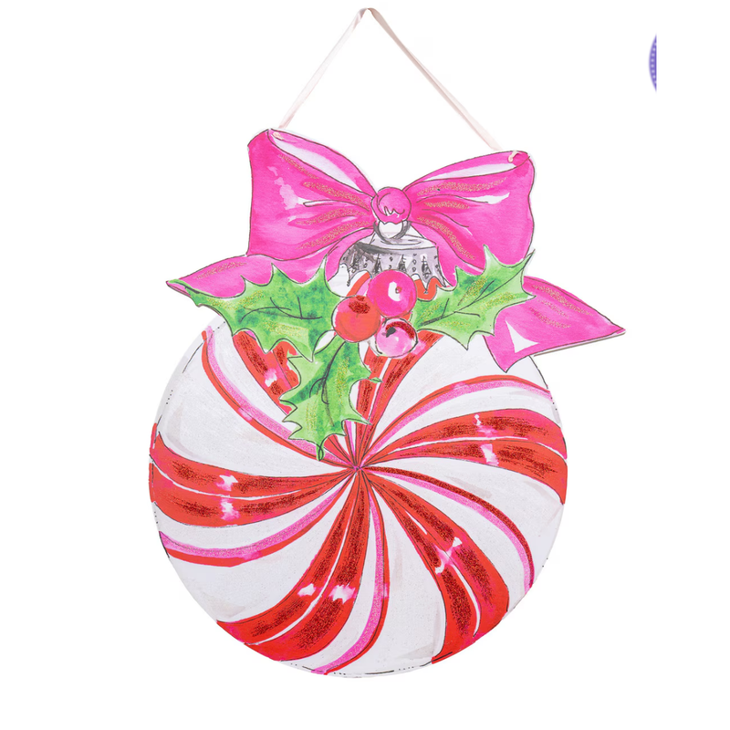 Decorative Christmas ornament with peppermint candy and pink bow on a white background
