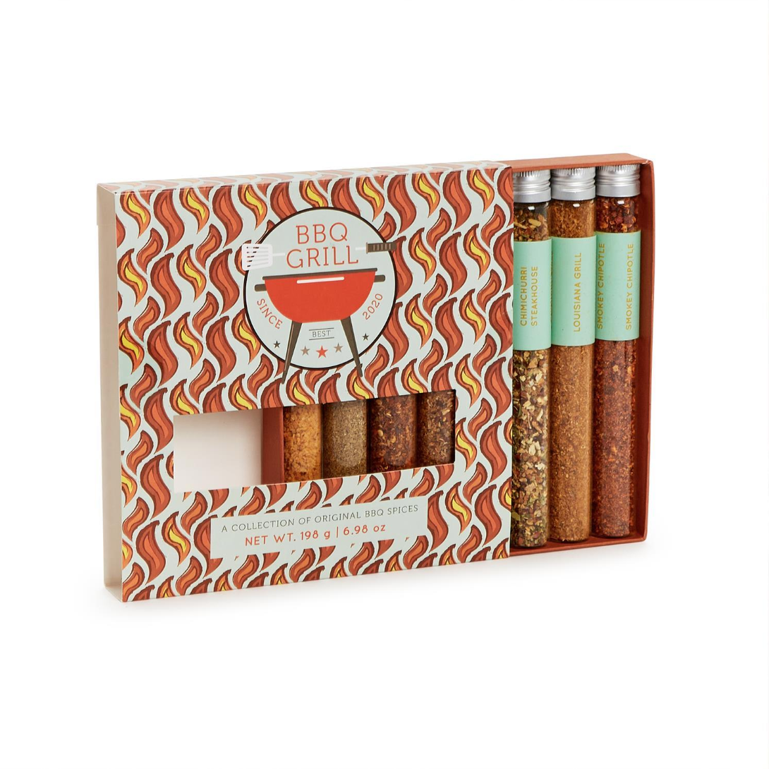 A boxed set of barbecue spices on a white background. The gift set includes a patterned box with a circular 'BBQ GRILL' logo and four spice tubes visible on the right side with mint green labels.