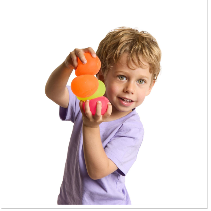 Child holding a colorful toy with a white background