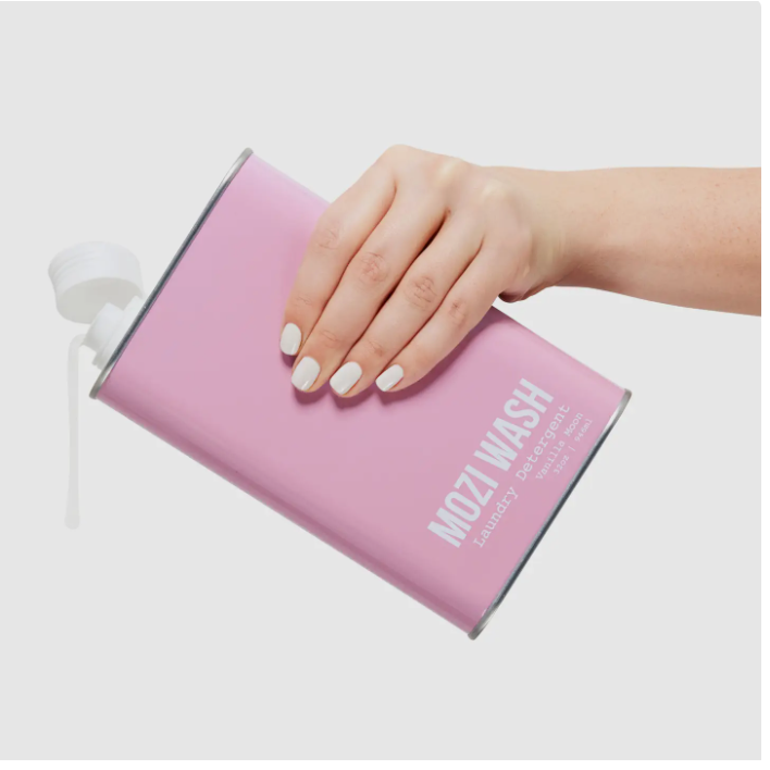 Pink Mozi Wash product held by a hand on a white background