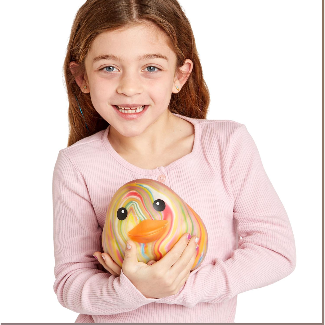 Young girl holding a colorful rubber duck toy against a white background