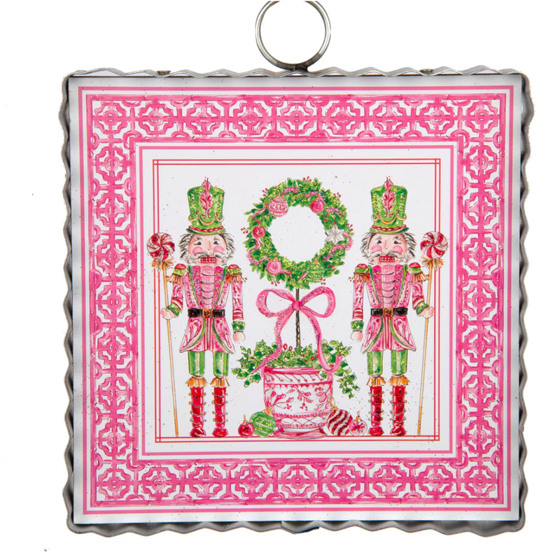 Decorative tile with two nutcrackers and a wreath on a pink border