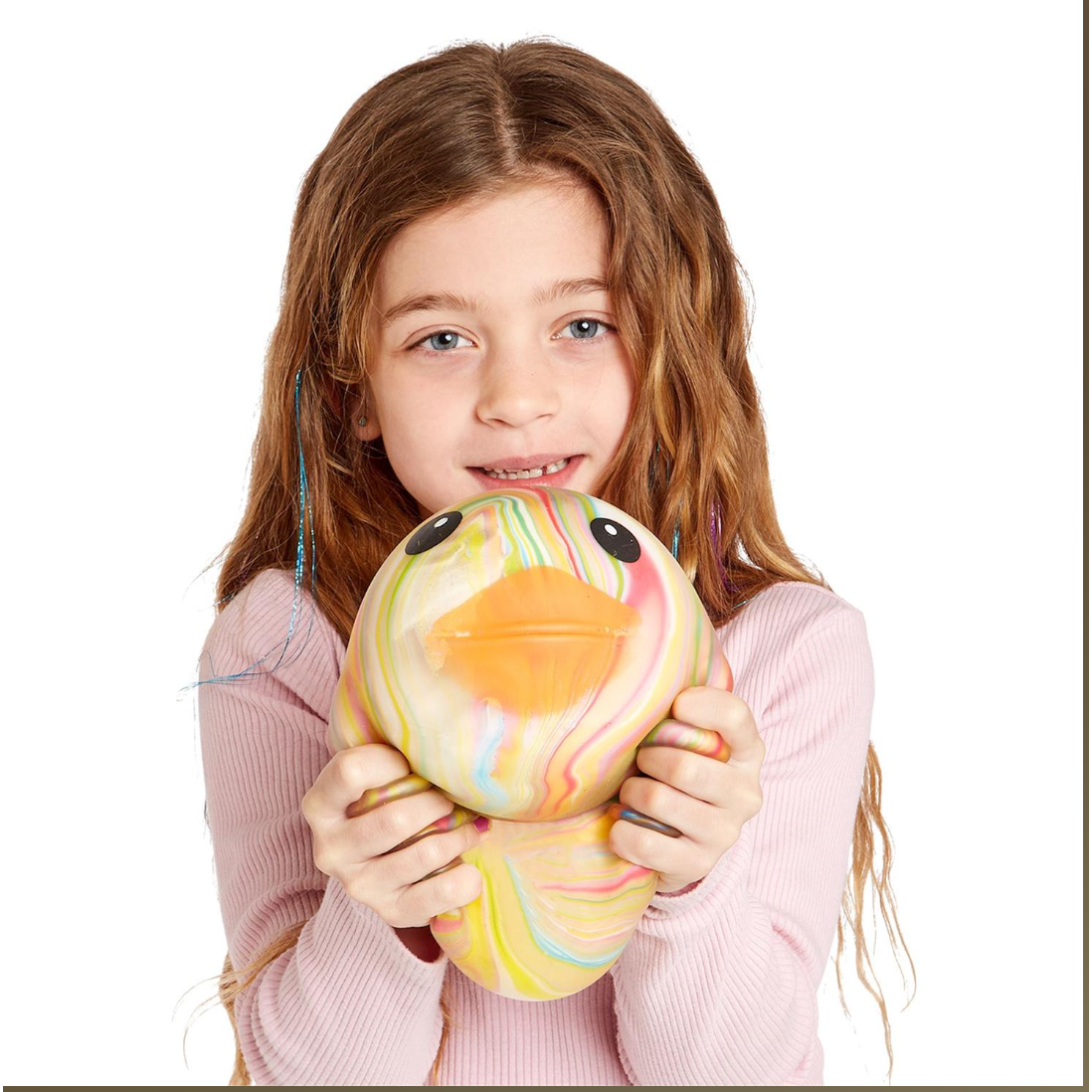 Young girl holding a colorful plush toy against a white background