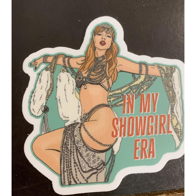 Sticker of a showgirl with text 'In My Showgirl Era' on a black background
