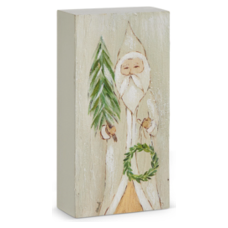 Wooden block with a painted design of a gnome holding a wreath and tree on a white background