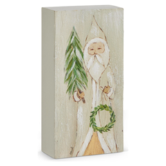Wooden block with a painted design of a gnome holding a wreath and tree on a white background