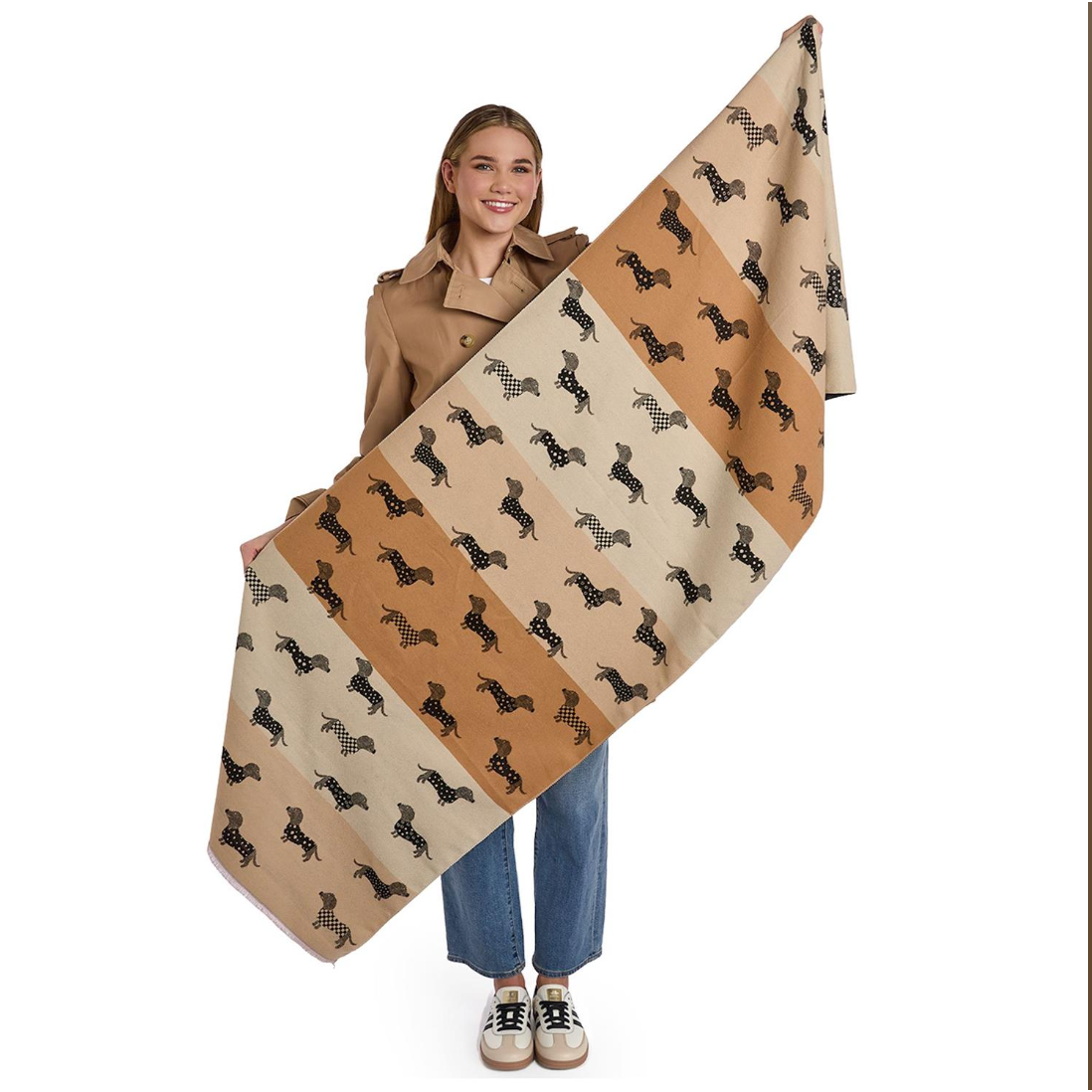 Woman holding a large beige blanket with black dog pattern on a white background