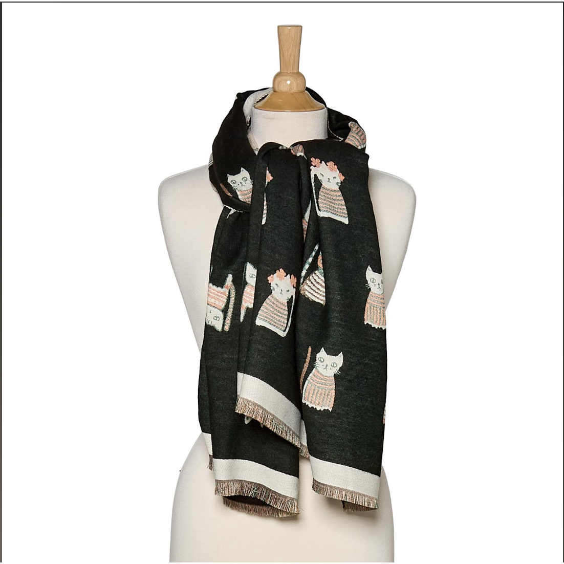 A black scarf with a pattern of white and pink cats wearing striped sweaters, draped on a cream-colored mannequin torso against a white background.