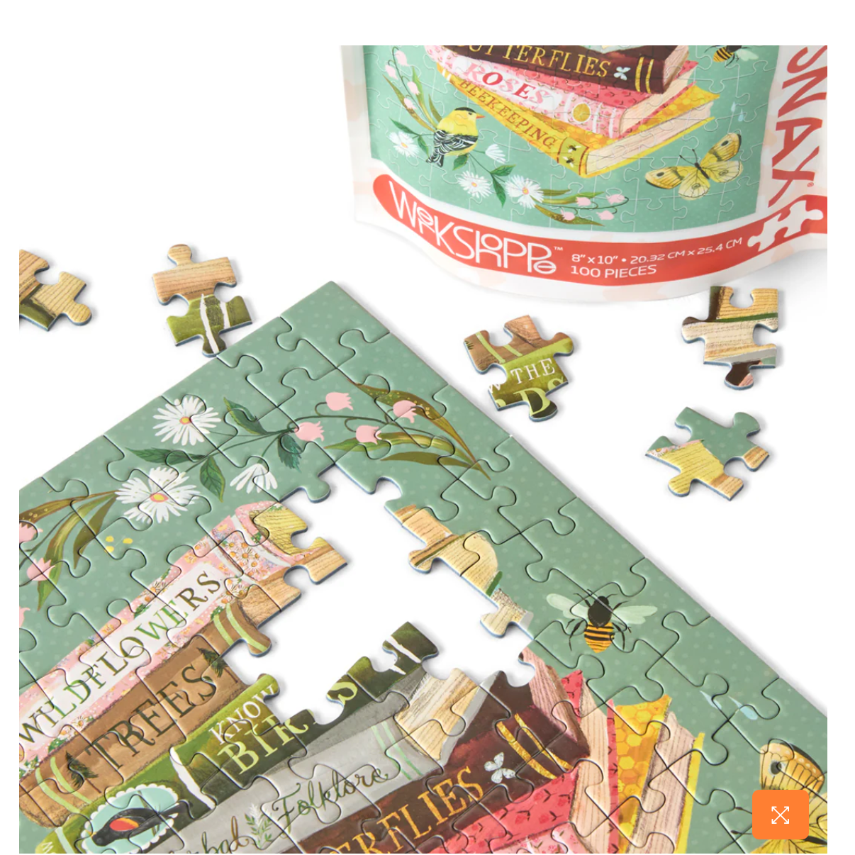 Jigsaw puzzle with nature-themed pieces and packaging in the background