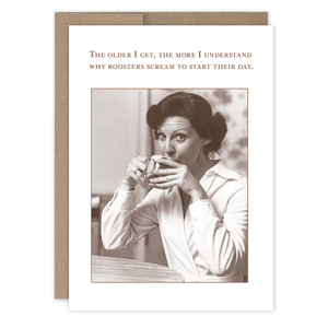 Greeting card with a woman drinking coffee and a humorous quote about roosters on a white background.