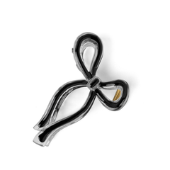Black bow-shaped brooch on a white background