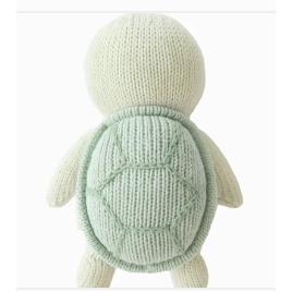 Knitted turtle toy with a light green shell on a white background