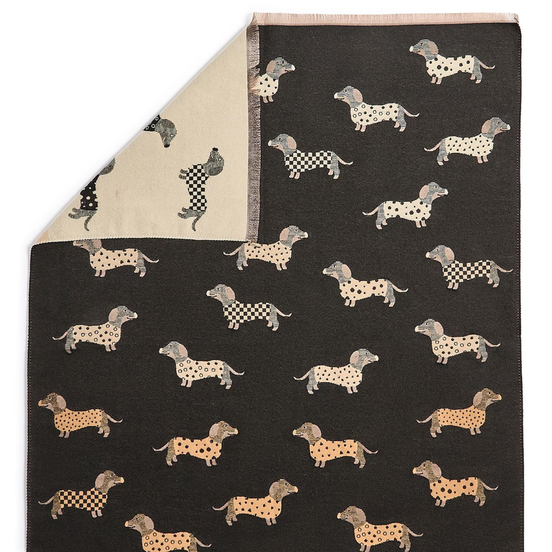 Folded fabric with dachshund pattern on a black background