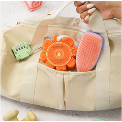 Beige bag with a comb, orange scrubber, and green lock on a light background