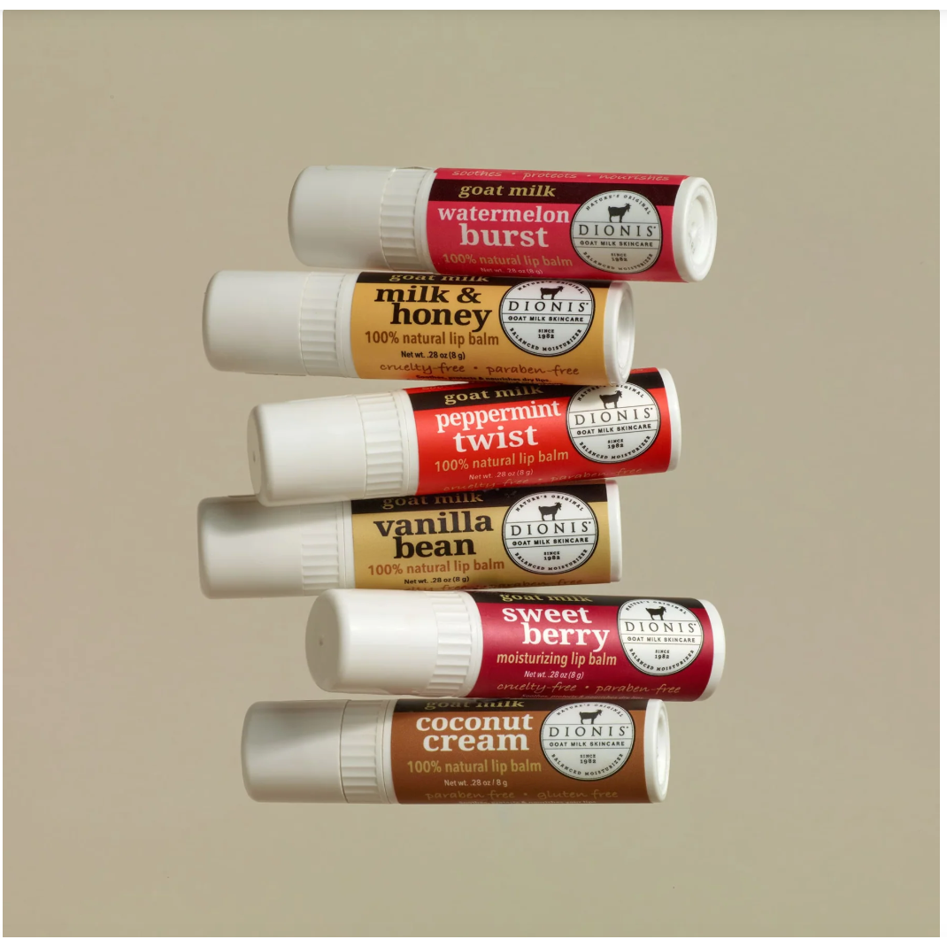 Set of Dionis lip balm tubes in various flavors on a beige background