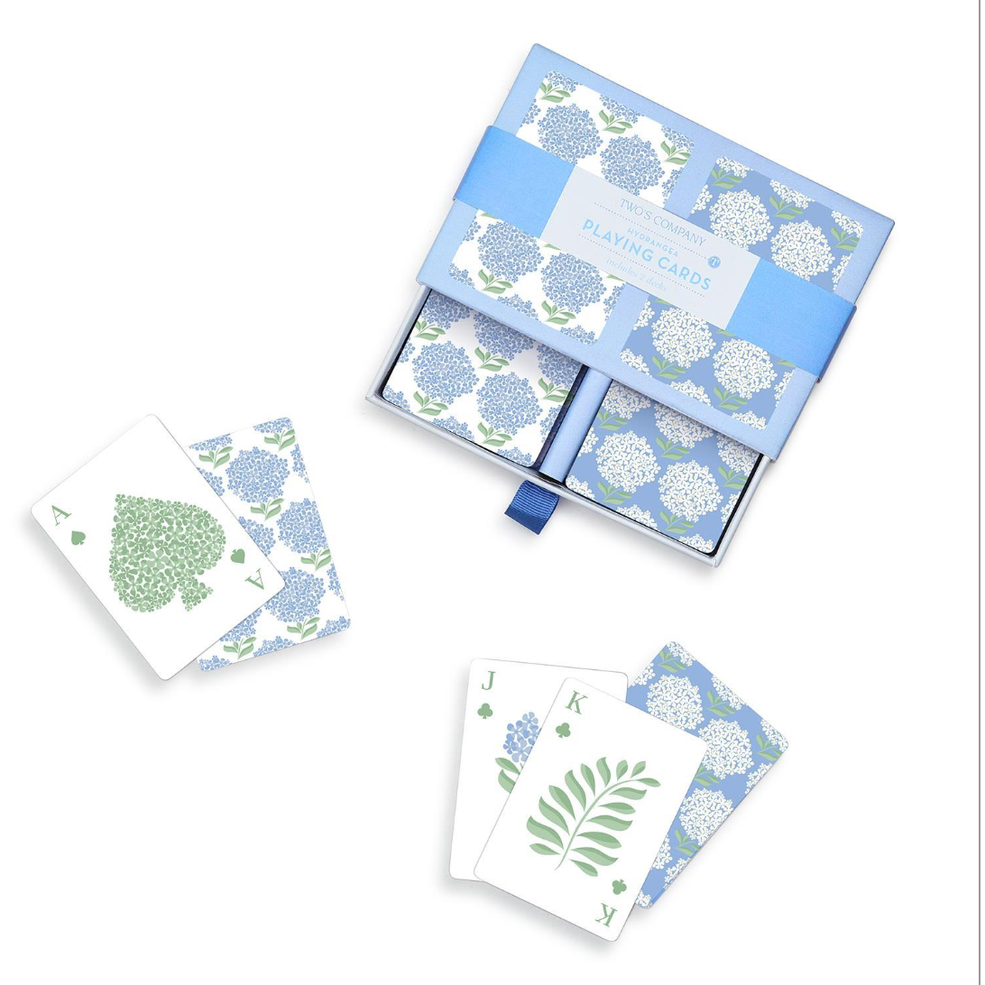 Set of playing cards with floral design in a box on a white background