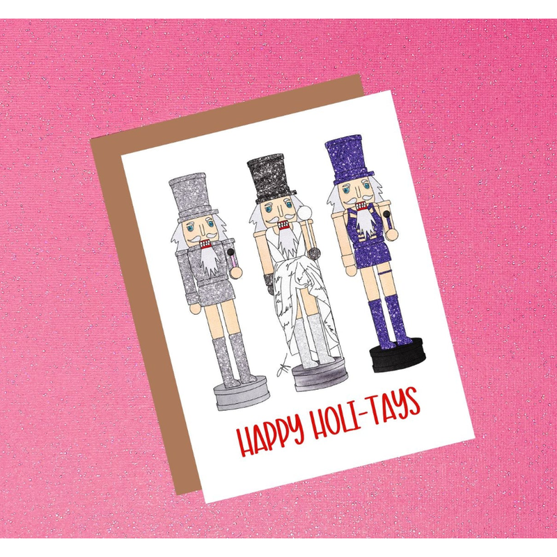 Card with nutcracker illustrations and 'Happy Holi-Tays' text on a pink background