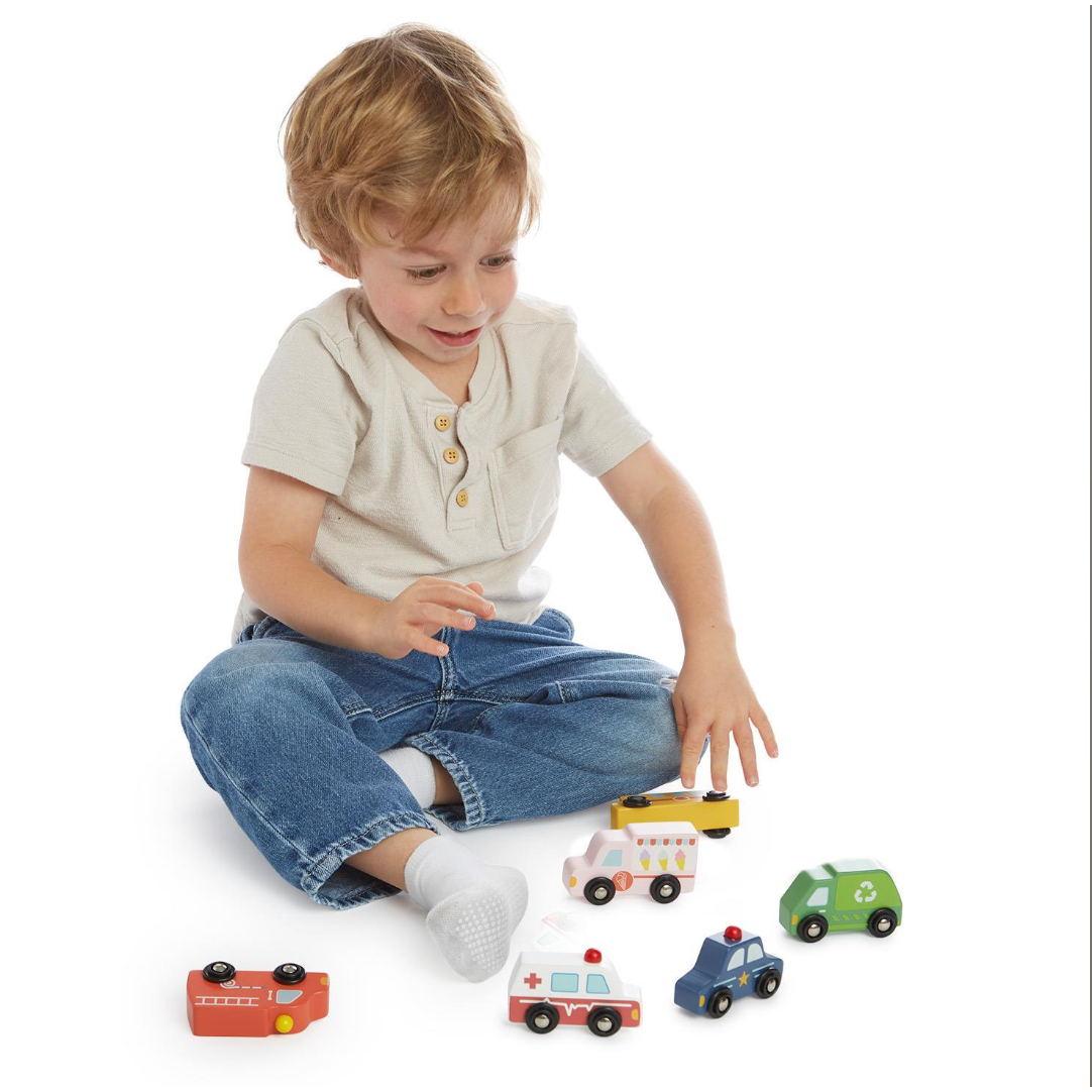 Child playing with toy cars on a white background