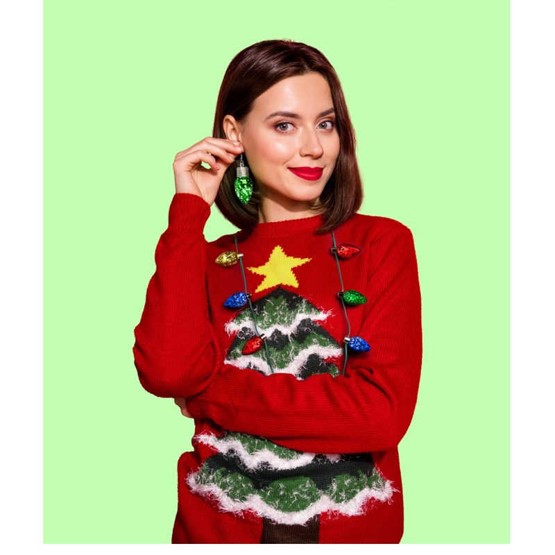Woman wearing a red Christmas sweater with a tree design on a green background