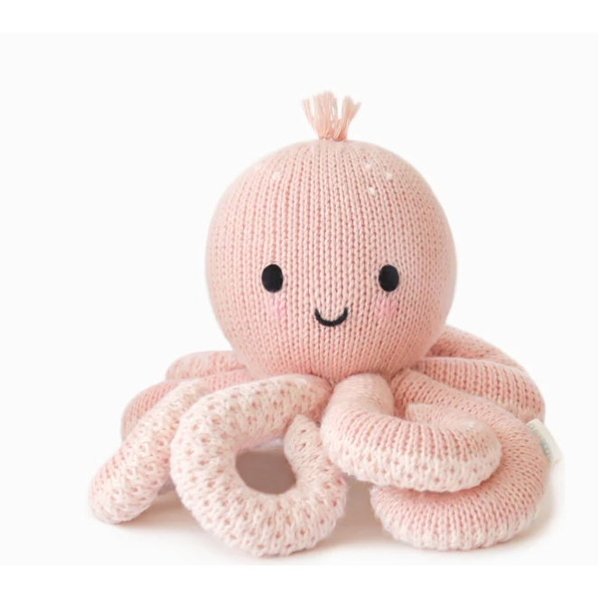 Knitted pink octopus toy with a white background