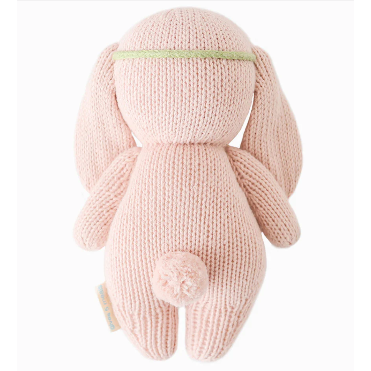 Knitted pink bunny toy on a white background
