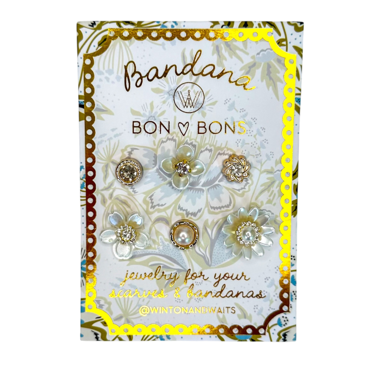 A set of six jewelry pieces for making and bandanas by Bon V Bon's, displayed on a decorative white and gold backing card. The jewelry includes three gold-toned textured beads, one pearl-and-gold bead, and three white flower-shaped beads with clear rhinestone centers.