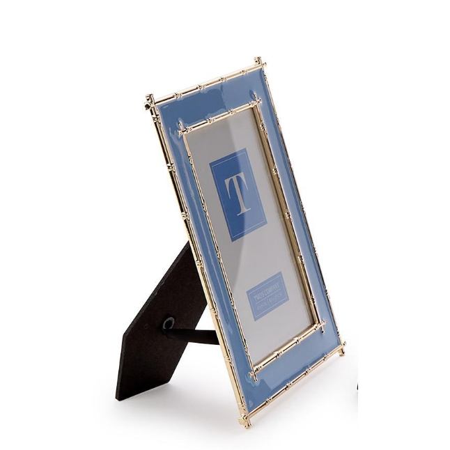 Decorative picture frame with blue glass and gold trim on a white background
