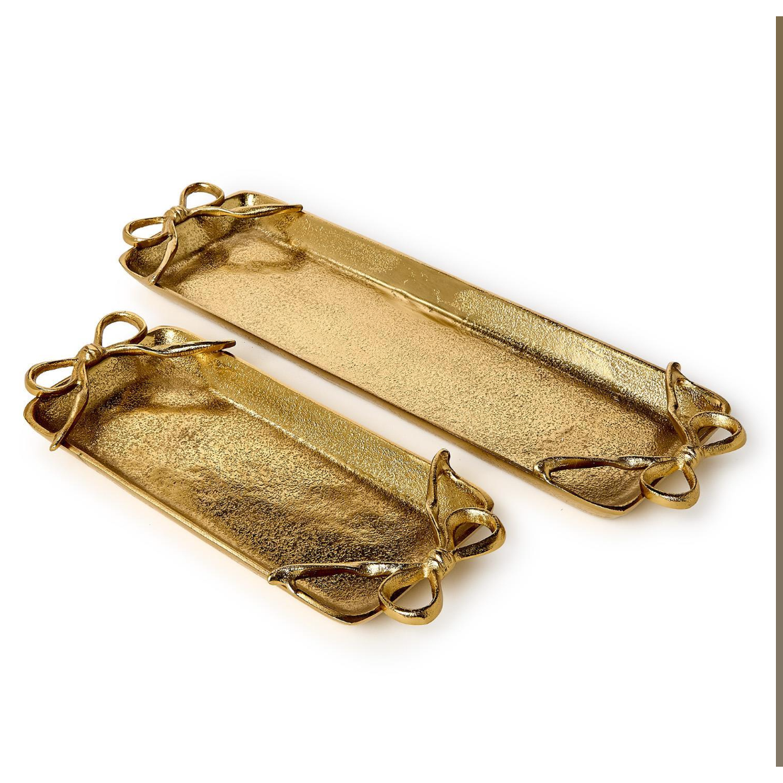 


Two gold decorative trays with leaf-like designs on a white background